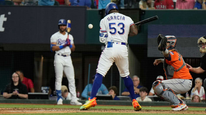 Texas Rangers' Adolis Garcia (53) is hit by a pitch thrown by Houston Astros relief pitcher Bryan Abreu during the eighth inning in Game 5 of the baseball American League Championship Series Friday, Oct. 20, 2023, in Arlington, Texas. (AP Photo/Godofredo A. Vásquez)